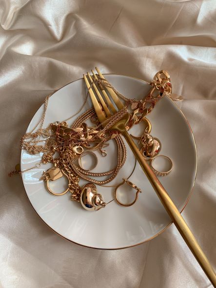 Gold jewellery on a plate depicting Is gold still a good investment?